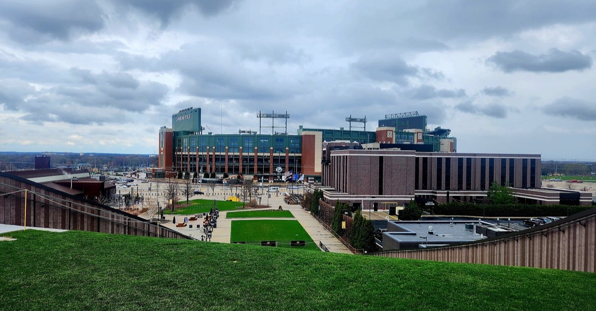 Lambeau Field in Green Bay seen from the Titletown hill under a cloudy sky