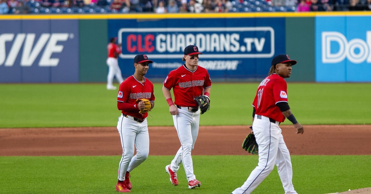 Cleveland Guardians fielders walk off the infield at Progressive Field during a game against the Tampa Bay Rays