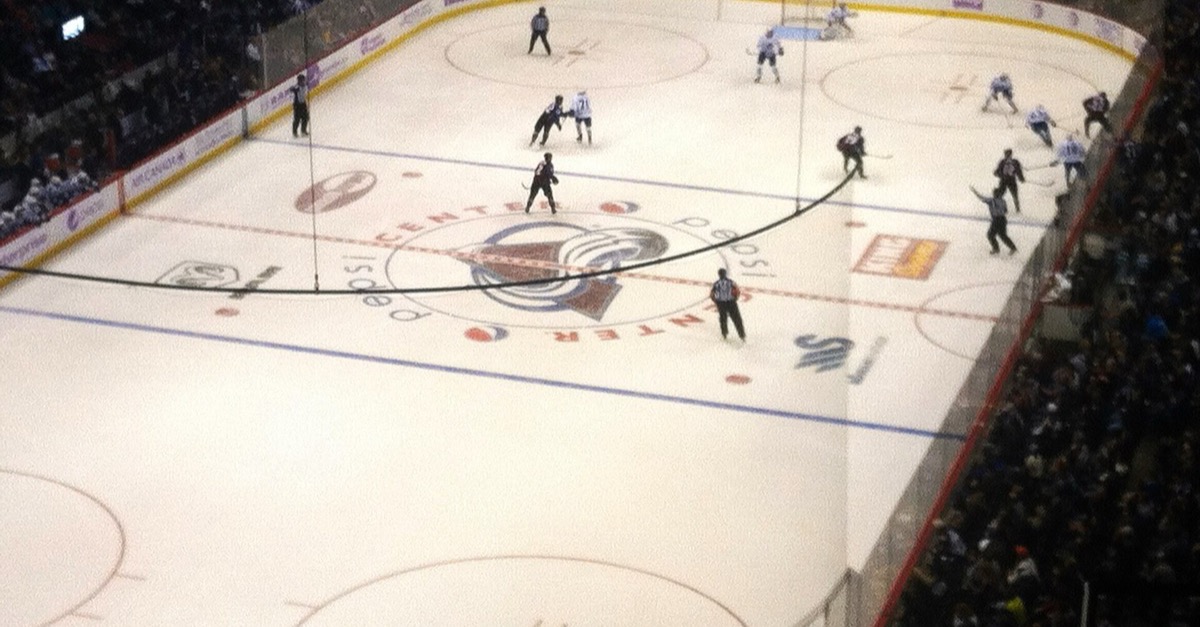 Colorado Avalanche and Toronto Maple Leafs players on the ice in Denver during a November 2014 game