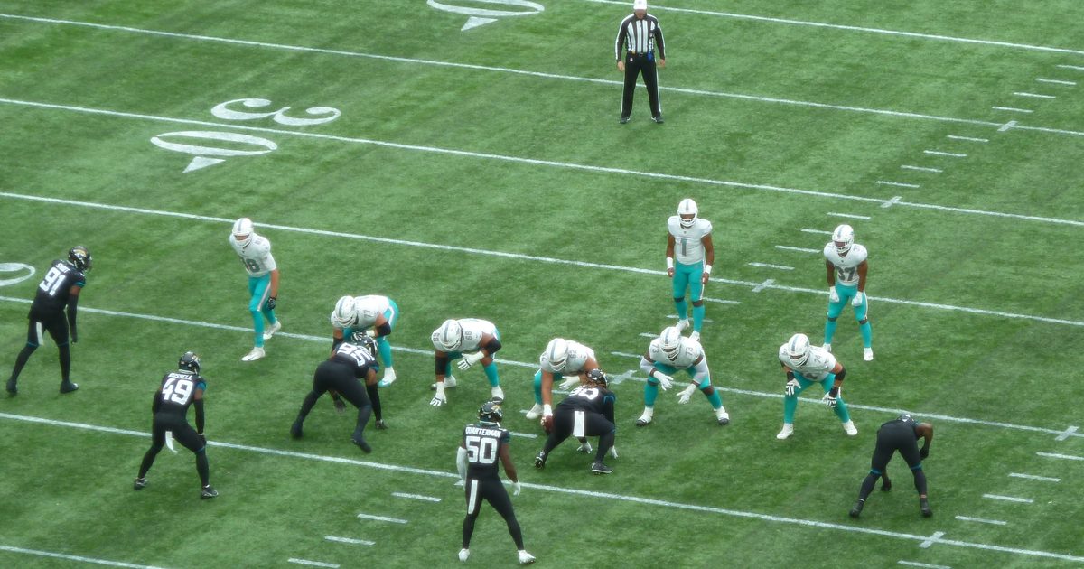 Jaguars and Dolphins players at the line of scrimmage at Tottenham Hotspur Stadium, London, in October 2021