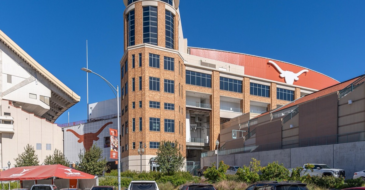 The brick tower and longhorn-marked upper deck of Darrell K Royal-Texas Memorial Stadium in Austin on a sunny day